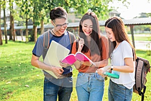Three Asian young campus students enjoy tutoring and reading boo