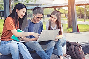 Three Asian young campus students enjoy tutoring and reading boo