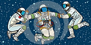 Three astronauts in space in zero gravity
