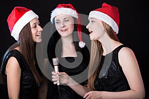 Three attractive young women singing