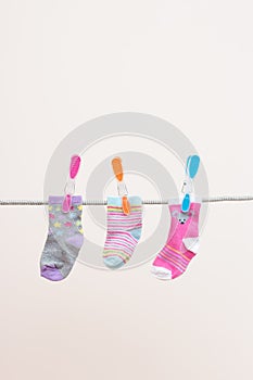 Three Babies Socks On Washing Line