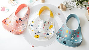 Three baby bibs with different colors and patterns