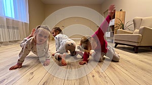 Three baby girls triplets sister are dancing at home in the room, pajamas are dressed