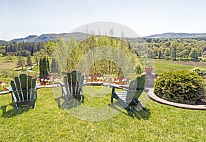 Adirondack chairs on grass lawn overlooking Berkshires in Spring photo