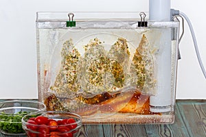 Three bags of chicken breast sous-vide cooking photo