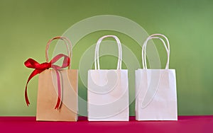 Three bags decorated with bow on red and breen bac