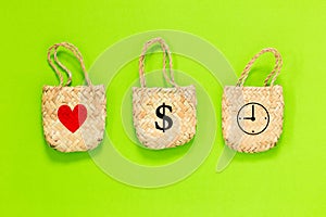 Three bags with heart, dollar sign, and clock icon on green background