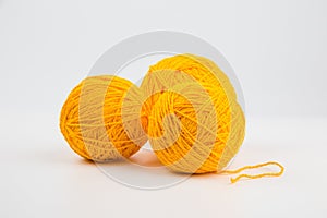 Three balls of yellow thread for knitting or crocheting