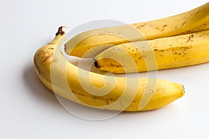 Three bananas on a white background in the corner frame of the photo.