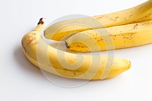 Three bananas on a white background in the corner frame of the photo.
