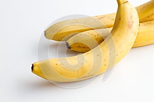 Three bananas on a white background in the corner frame of the photo.