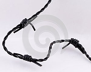 Three barbs strand of black Barbed Wire on white background