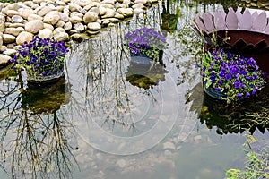 Three baskets full of purple on the water.