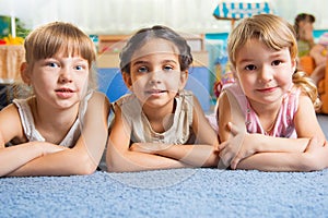 Three beautiful girls lying on floor