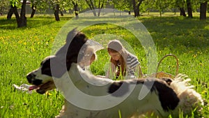 Three beautiful girls are playing in the garden with a vintage sun umbrella