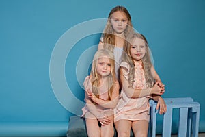 Three beautiful little girls dresses fashion portrait sisters