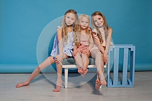 Three beautiful little girls dresses fashion portrait sisters