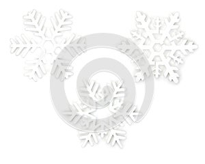Three beautiful white decorative snowflakes. Isolated on white background, close-up, top view