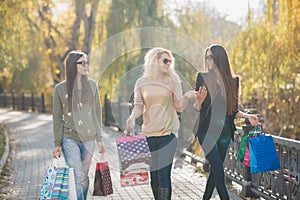 Three Beautiful Young Women with Shopping Bags.