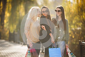 Three Beautiful Young Women with Shopping Bags.