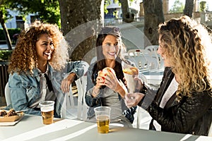 Three beautiful young women visiting eat market in the street.