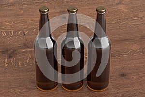 Three beer bottles 500ml mock up on wooden background