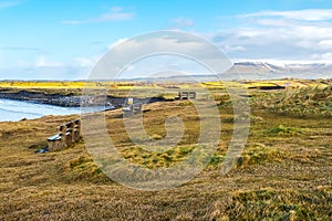 Three benches with view on Atlantic ocean, Rosses point beach and Benbulben mountain covered with snow in county Sligo, Ireland,