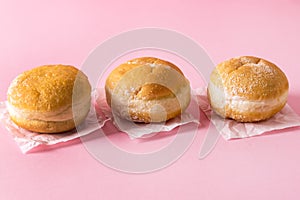 Three Berliner Doughnuts European Donuts Tradicional Bakery for Fasching Carneval Time Horizontal Pink Background