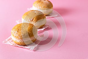 Three Berliner Doughnuts European Donuts Tradicional Bakery for Fasching Carneval Time Horizontal Pink Background