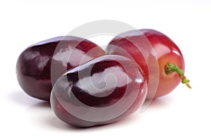 Three berries of red grapes close up.