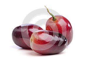 Three berries of red grapes close up.