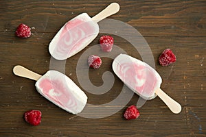 Popsicle with fresh raspberry on a table