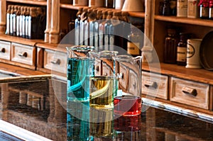 Three berzelius glasses with colored liquid