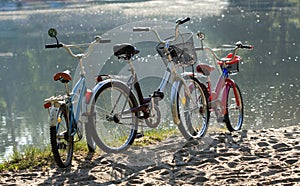 Three bicycles on a beach.