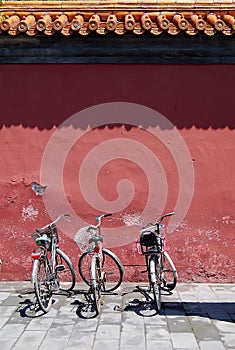 Three bicycles under old wall