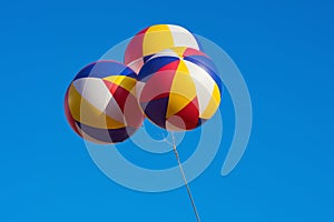 Three big balloons flying against blue sky