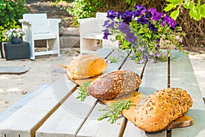 Three big breads outside on a table