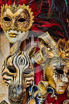 Three Bightly Colored and Feathered Masks in Venice Venezia It