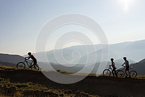 Three bikers on a mountain trail