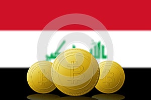 Three Bitcoins cryptocurrency with Irak flag on background photo