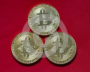 Three bitcoins isolated on red