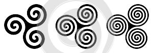 Three black celtic triskelion spirals over white photo