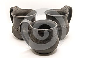three black ceramic mugs on a white background