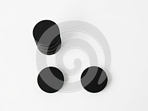 Three black circular objects on a white surface