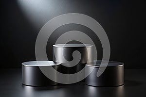 Three black cylindrical podiums on a black background