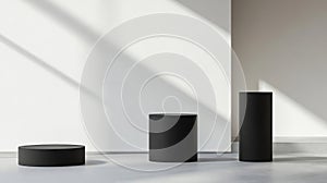 Three Black Cylindrical Podiums on a White and Gray Background