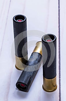 Three black 410 gauge slug shot gun shells