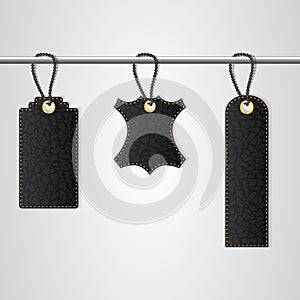 Three black leather VIP tag with gold thread hang on the bar.