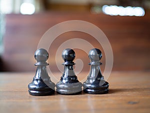 Three black pawns. Chess business idea for competition in world market, success and leadership concept