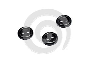 Three black plastic buttons, isolate on a white background